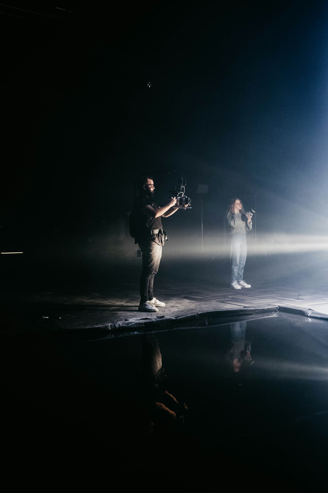 a-couple-of-people-standing-on-top-of-a-stage-0qgrctke5p0