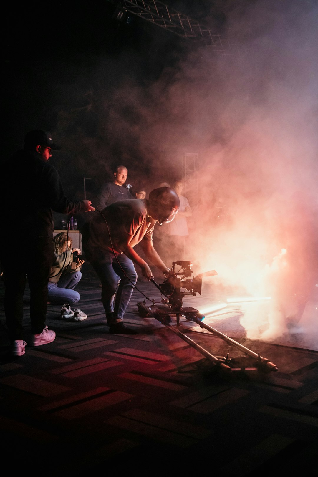 a-group-of-people-standing-around-a-fire-5dork0z4nee