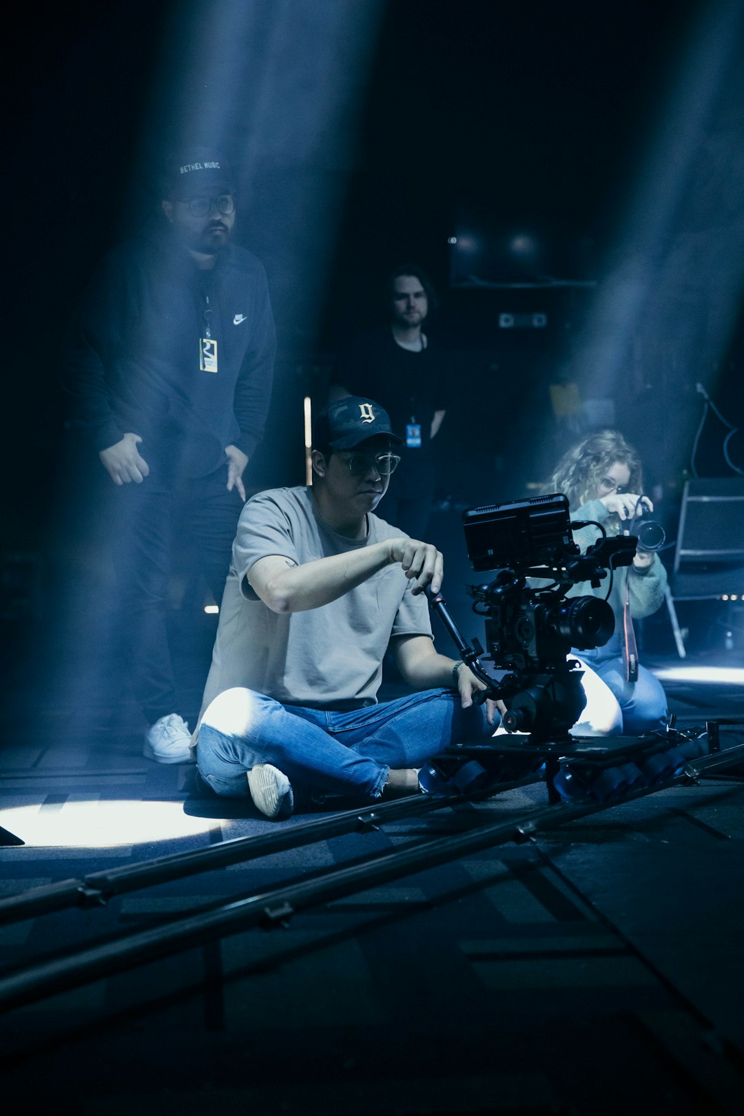 a-man-sitting-on-the-ground-in-front-of-a-camera-snlqyw8cxza