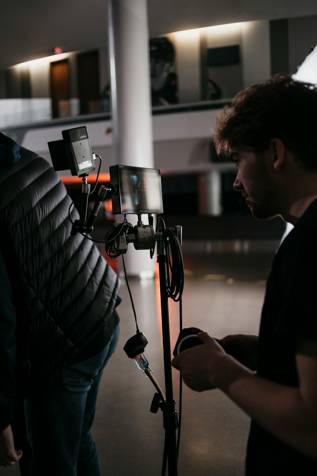 a-man-standing-next-to-a-camera-on-a-tripod-gaky9zgic2g