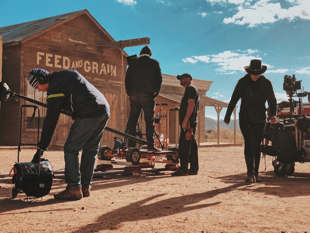 four-men-standing-outside-feed-and-grain-store-iwfhhozlvmu